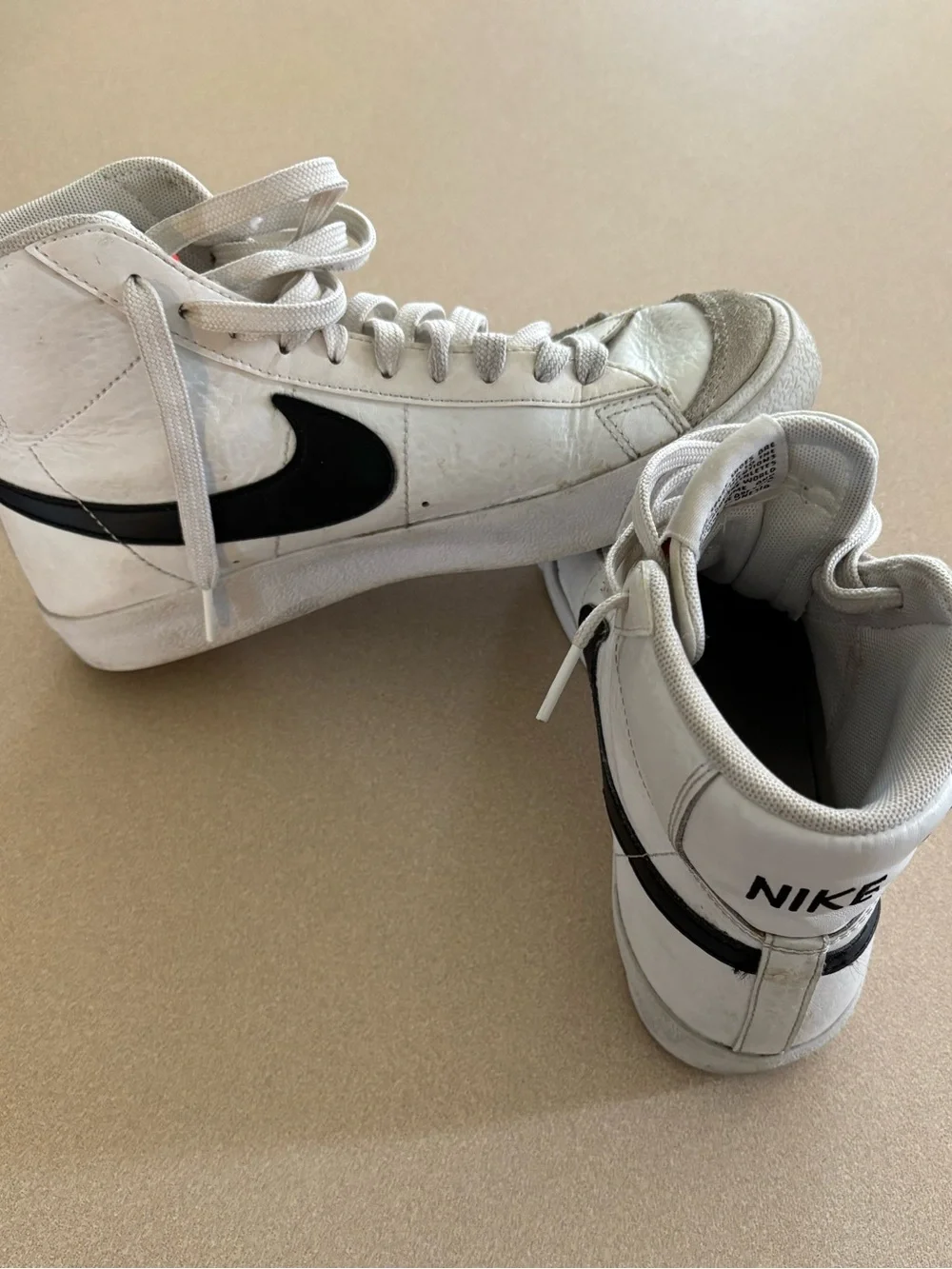 Nike Women’s White and Black High-Top Sneakers with Iconic Swoosh